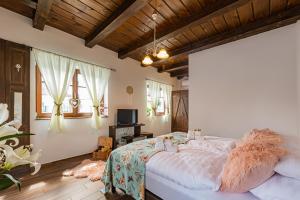 a bedroom with a large bed in a room with wooden ceilings at Boróka Vendégház Tóalmás in Tóalmás