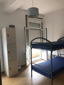 a bedroom with a bunk bed and a desk at Albergue San Martin in Tui