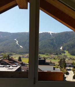 a view of the mountains from a window at Appartamento Riscone Nuvola di Plan in Brunico