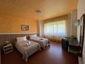 Voodi või voodid majutusasutuse Park Hotel Bozzi toas