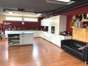 a large kitchen with a black couch in a room at Modtrip Switzerland in Grünenmatt