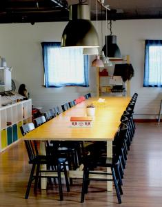 a large wooden table with chairs in a room at Modtrip Switzerland in Grünenmatt +23 photos