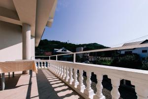 a balcony of a building with a white railing at Agropensiunea Ozon in Piatra Neamţ