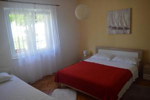 a bedroom with two beds and a window at Goga Apartments in Primošten