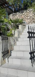 a set of white stairs with black railing at Apartment Nono Ivo in Vis