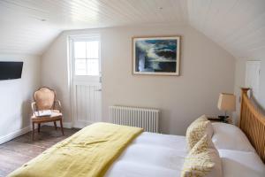a bedroom with a bed and a picture on the wall at Wheelwrights Arms Country Inn & Pub in Bath