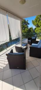 a patio with couches and chairs on a patio at Apartment Nono Ivo in Vis