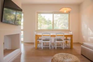 a dining room with a table and chairs and a window at Villaggio Gargano in Vieste