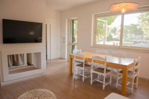 a dining room with a table and a tv at Villaggio Gargano in Vieste