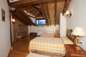 a bedroom with two beds and a couch in it at APARTAMENTOS LA COTERA sc in Cambarco +106 photos