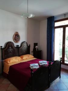a bedroom with a large bed with a red blanket at Agriturismo I Fondacci in Grizzana