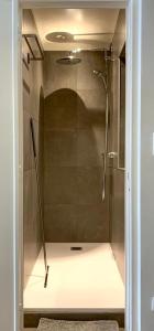 a shower with a glass door in a bathroom at Appartement Giulia in Knokke-Heist +29 photos