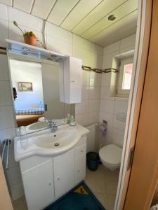 a bathroom with a sink and a toilet at Gästehaus Waltraud in Längenfeld +42 photos