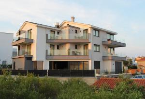 a building with balconies on the side of it at Pansion Leggero in Krk