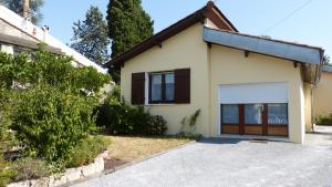 a house with a garage in front of it at Apartment Le Jardinet in Talence