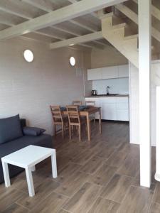 a living room with a couch and a table at Domek Ga-Ba in Sarbinowo