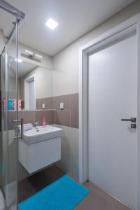 a bathroom with a sink and a mirror at Bright Studio, 10min Centre, Free Parking in Prague