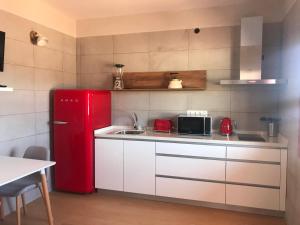 a kitchen with a red refrigerator and a sink at La Hoya del Cura in Valle Gran Rey