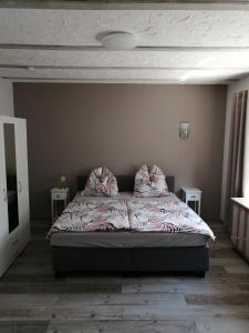 a bedroom with a bed with two pillows on it at Ferienwohnung Monecke in Hürtgenwald