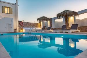 a swimming pool with blue water in a house at Marble Art Villas in Panormos