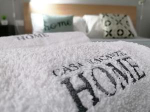 a white blanket that says happy new year on a bed at Vacanze HOME in Caltanissetta