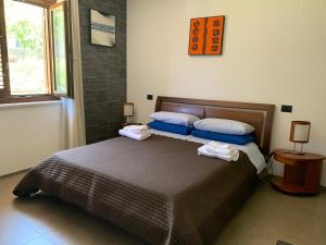 a bedroom with a bed with two towels on it at Villa Amalia in Avellino