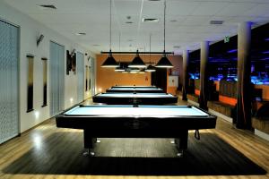 a row of pool tables in a rec room at HOTEL NIAGARA in Konin