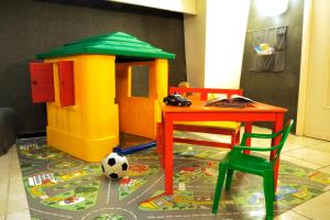 a toy play area with a table and a soccer ball at Hotel Del Golfo in Laigueglia