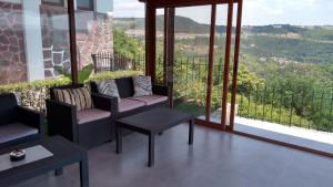 a screened in porch with two chairs and a table at Guest House Harmony in Veliko Tŭrnovo
