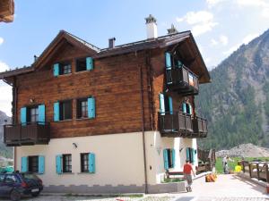 a wooden building with balconies on a mountain at Art Apartments Casa Napell in Livigno