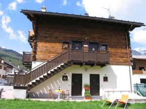 a house with a deck on the side of it at Art Apartments Casa Napell in Livigno
