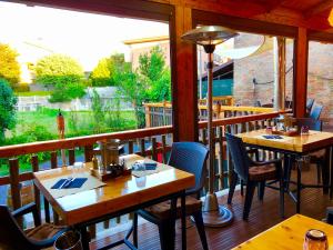 a restaurant with tables and chairs on a balcony at B&B Locanda Wellness Carlos Grill BBQ in Grinzane Cavour