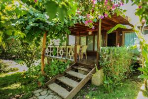 a house with a wooden staircase leading to a porch at Villa Zeytin in Cıralı