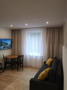Televízia a/alebo spoločenská miestnosť v ubytovaní Apartament Izerski Raj