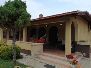a house with a porch with a hammock on it at Kuća na dan Villa Holiday in Sakule