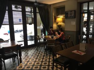 two people sitting at a table in a restaurant at Campbell House in George Town