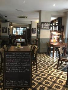 a restaurant with tables and chairs and a menu at Campbell House in George Town