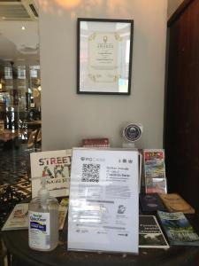 a table with books and a picture on the wall at Campbell House in George Town
