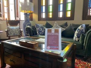a living room with a green couch and a table at Campbell House in George Town