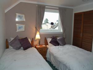 A bed or beds in a room at Dalbeattie Guest House 