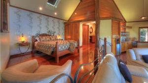 a bedroom with a bed and a living room at Secrets on the Lake in Montville