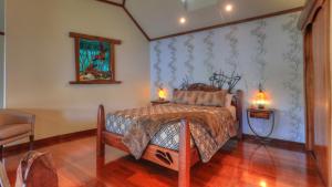 a bedroom with a bed and two lamps on tables at Secrets on the Lake in Montville