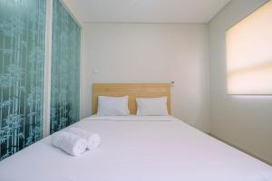 Ένα ή περισσότερα κρεβάτια σε δωμάτιο στο Enjoy 1BR Apartment at Atlanta Residence By Travelio +10 φωτογραφίες
