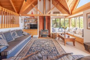 a living room with a couch and a fireplace at Pointers - Akaroa Holiday Home in Akaroa