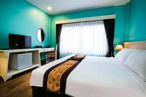 Un ou plusieurs lits dans un hébergement de l'établissement La Seine City Resort, Chiang Mai