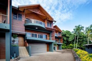 a house with a balcony and a garage at Toscana Village Resort in Airlie Beach