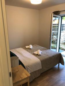 a bedroom with a bed with two towels on it at Apartman Linda in Cres