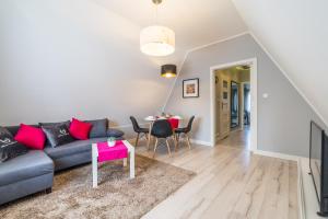 a living room with a couch and a table at ApartamentyGdanske EU - Golden in Gdańsk