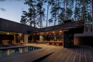 a house with a swimming pool and a wooden deck at Verholy Relax Park in Sosnovka