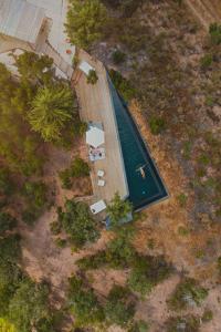 an overhead view of a swimming pool with a deck at The ONE - Country House in Grândola